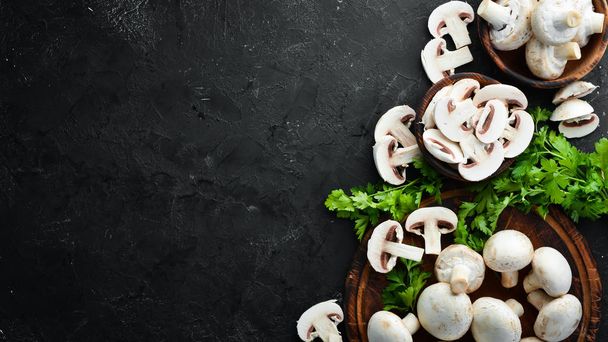 Mushrooms sliced on a black table surface. Top view. Free space for text. - Fotoğraf, Görsel