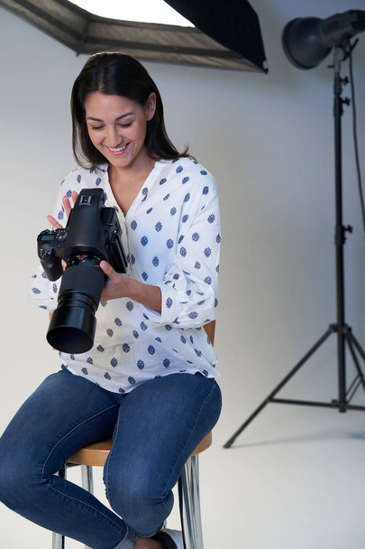 Female Photographer In Studio For Photo Shoot With Camera And Li - Photo, Image