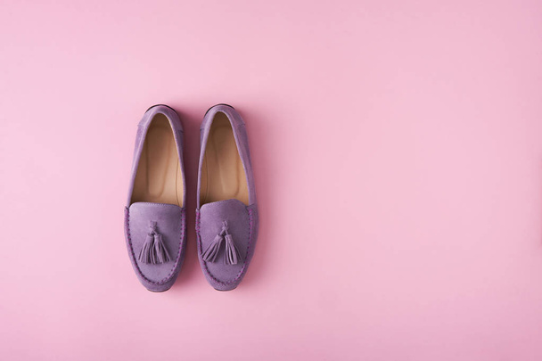 Lilac suede moccasins shoes over lilac pink background - Fotó, kép