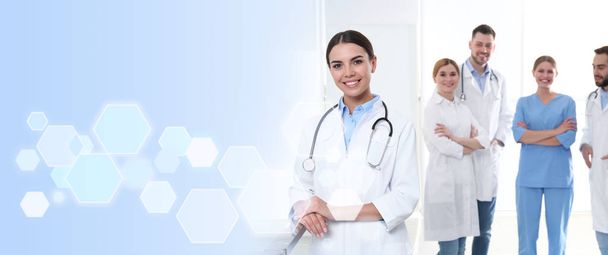 Doctor with colleagues in clinic, space for text. Medical service - Φωτογραφία, εικόνα