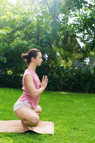 Chica haciendo yoga al aire libre en el prado natural
 - Foto, imagen
