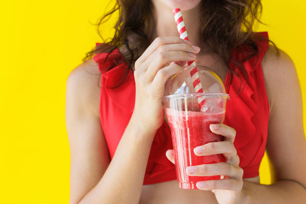 Happy young brunette woman drinks fruit juice - 写真・画像