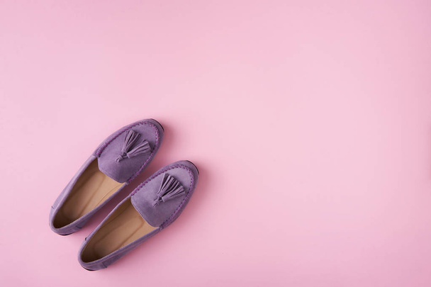 Lilac suede moccasins shoes over lilac pink background - Fotó, kép