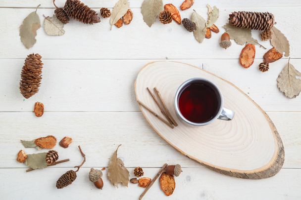 drink in a retro mug on a wooden background in the autumn style  - Photo, Image