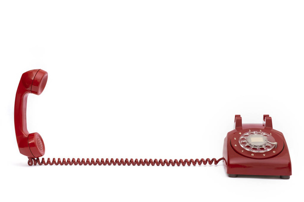 Rétro téléphone fixe rouge sur un fond blanc isolé
 - Photo, image