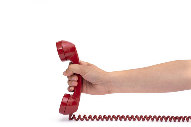 Retro vaste rode telefoon op een geïsoleerde witte achtergrond - Foto, afbeelding