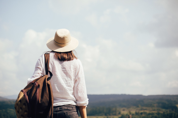 Hipster girl with backpack traveling and standing on top of sunn - Foto, Imagem