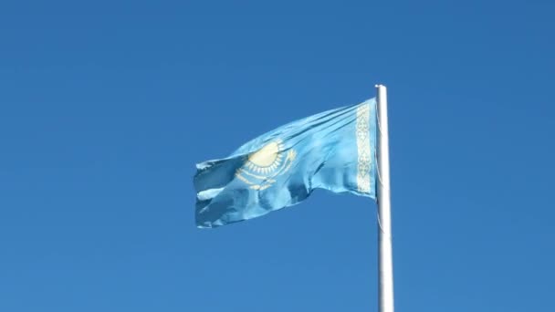 Glitch effect. Flag of the Republic of Kazakhstan on the flagpole waving on background blue sky. Video - Footage, Video