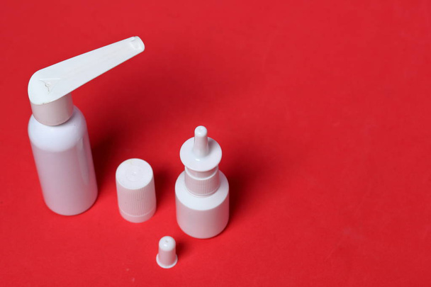 White spray nasal and oral spray. Against the background of coral color. View from above. - Фото, зображення