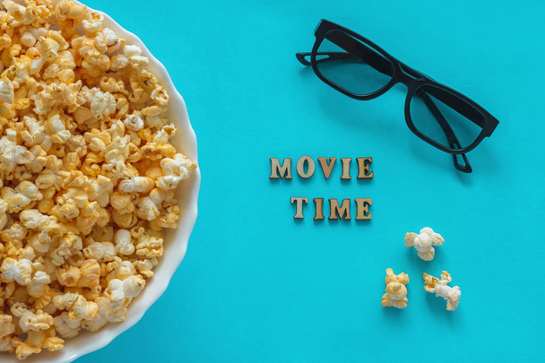 popcorn, TV remote and 3D glasses. Text "movie Time". - Photo, image