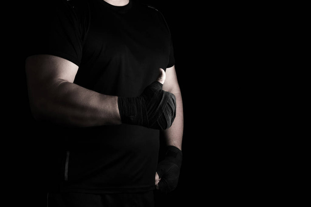 руки завернутые в черную эластичную спортивную повязку показывают, как знак
 - Фото, изображение