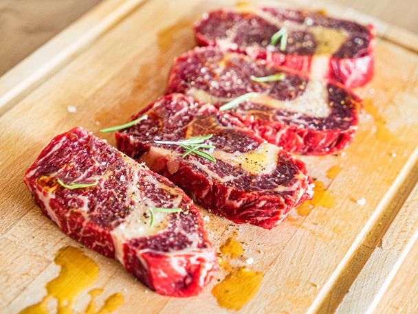 Large Raw Meat Steaks On Table, close up - Foto, Imagen