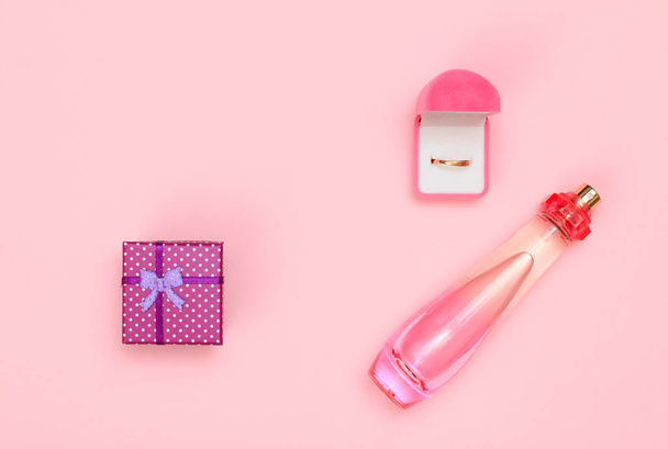 Gift boxes and cosmetics on a pink background - Photo, image