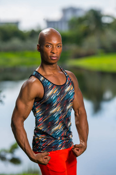 Portrait of an attractive man flexing his arms. Male model posin - Photo, Image