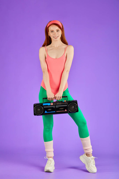 girl standing after active dance training, holding portable cassette player - Photo, Image