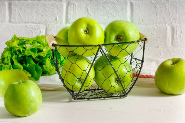 Зелені яблука в металевому кошику на білому тлі. Натуральне харчування, свіжі фрукти. дієта
. - Фото, зображення