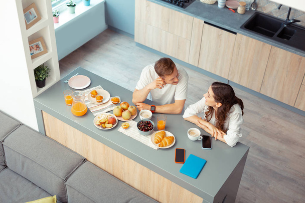 Top view of couple having croissants and coffee in the morning - Foto, afbeelding