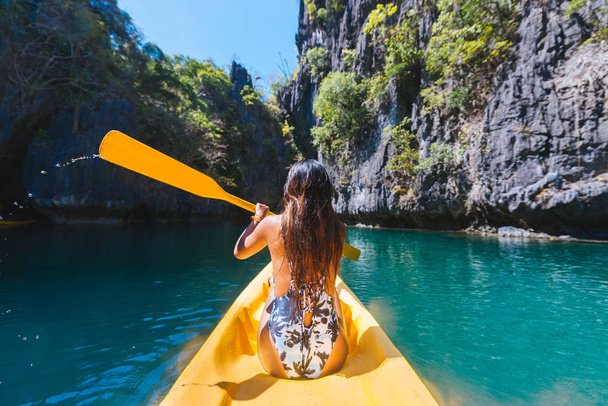 Woman kayaking in the Small Lagoon in El Nido, Palawan, Philippines - Travel blogger exploring south-east asia best places - Photo, Image