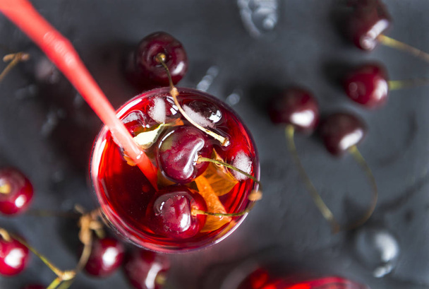 cherry, limonada glass of cherry on a black background, berries - Фото, зображення