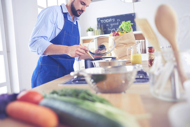 Man preparing delicious and healthy food in the home kitchen - Photo, image