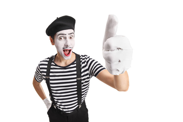 Cheerful young pantomime man showing thumbs up - Fotó, kép