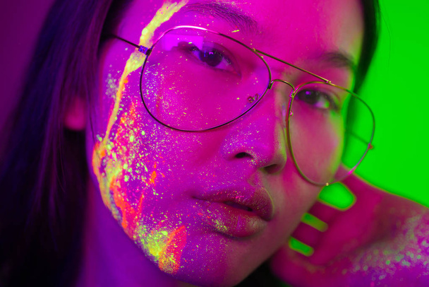 Fashion model with fluo painting on the face - Фото, изображение