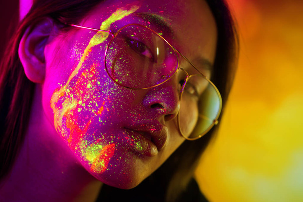 Fashion model with fluo painting on the face - Fotó, kép