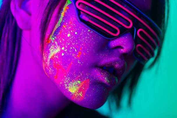 Fashion model with fluo painting on the face - Photo, Image