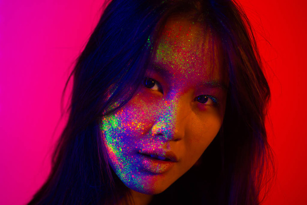Fashion model with fluo painting on the face - Foto, Imagen