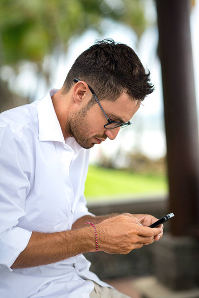 Young man using smart phone  - Фото, изображение