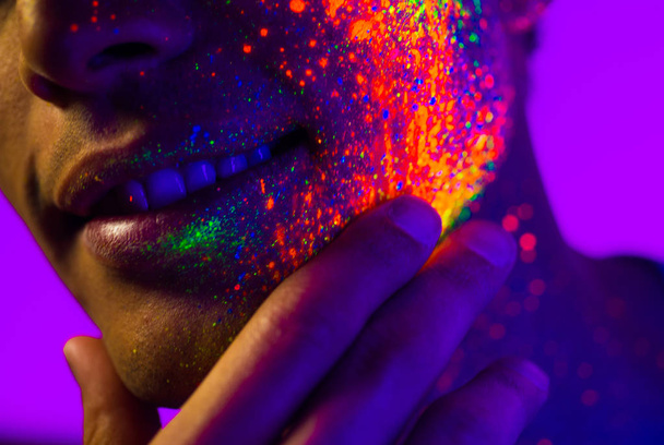 Fashion model with fluo painting on the face - Foto, imagen