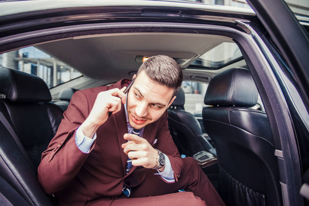Businessman sitting in stretch limo - Photo, Image