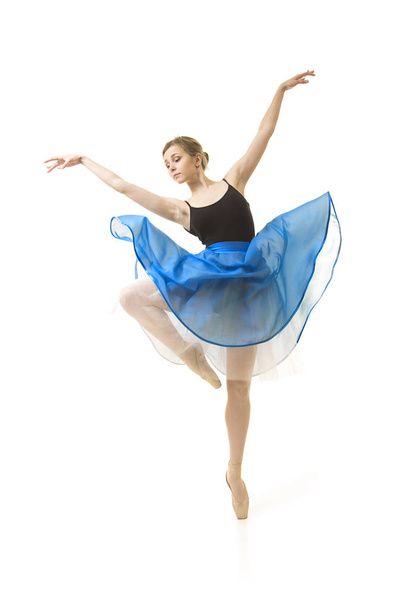 Girl in a blue skirt and a black leotard dance ballet. - Foto, Imagen