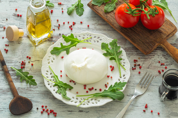 ブリラタ、トマト、スパイス、アルグーラ、オリーブオイル、バルサミコ酢のイタリアンチーズ  - 写真・画像