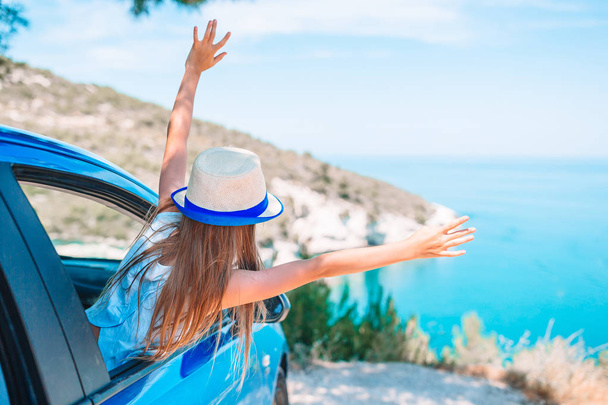 Little girl on vacation travel by car background beautiful landscape - Photo, Image