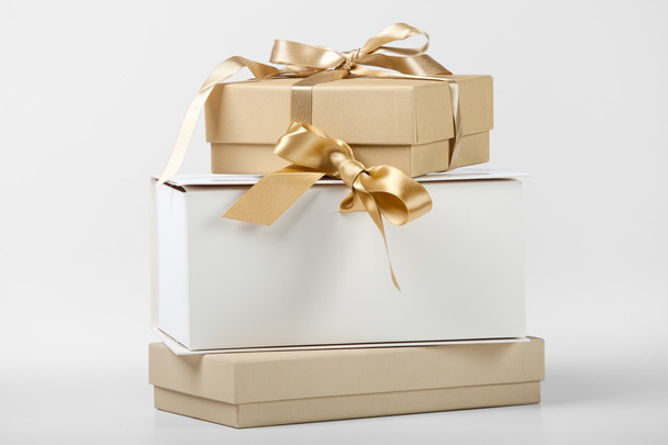 Three boxes with golden ribbon - Foto, imagen