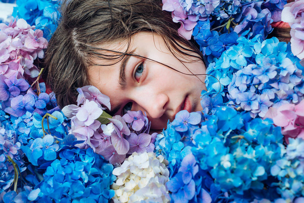 Summer beauty. Spring woman with hydrangea flowers. Fashion portrait of woman. Healthy hair and skin. Makeup cosmetics and skincare. girl with summer makeup. Forever young and free - Foto, Bild