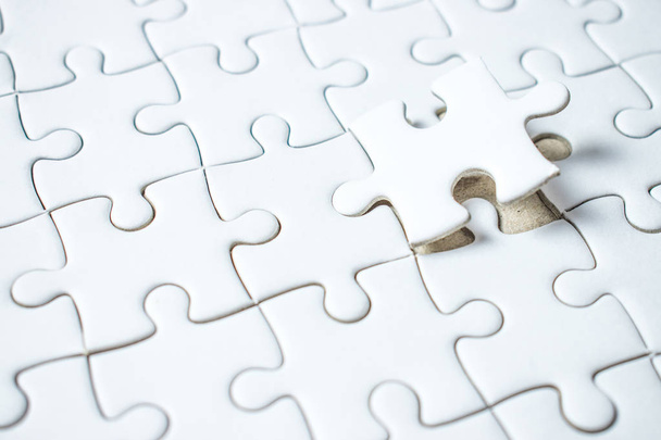 White puzzle with a piece missing. - Fotó, kép