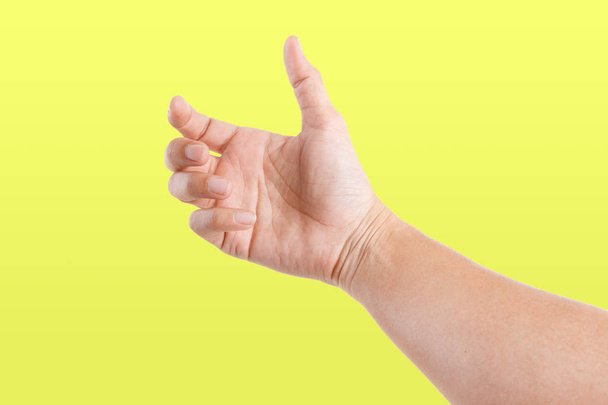 Samci asijských ručních gest izolovaných na žlutém pozadí. Zachytit pózu. - Fotografie, Obrázek