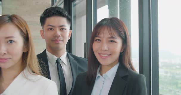 成功したアジアのビジネスチームは笑顔で一緒に立っている - 映像、動画