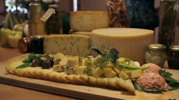 Man's hand picking served cheese from board - Footage, Video