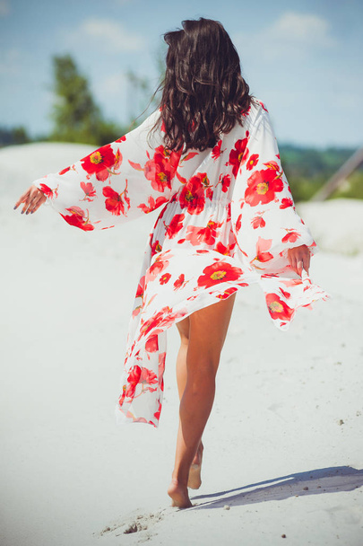Fashion outdoor photo of beautiful sensual woman with long dark hair in swimwear on the sand beach. - Фото, изображение