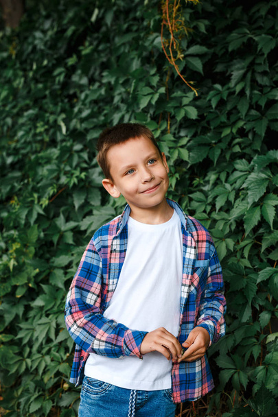 Portrait happy smiling boy wearing a checkered shirt outdoor - Fotoğraf, Görsel