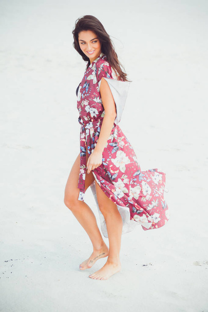 Fashion outdoor photo of beautiful sensual woman with long dark hair in swimwear on the sand beach. - Photo, image
