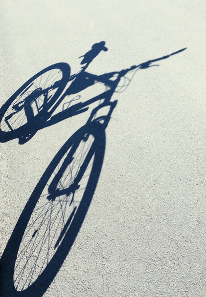 Bicycle shadow on an asphalt road - Φωτογραφία, εικόνα