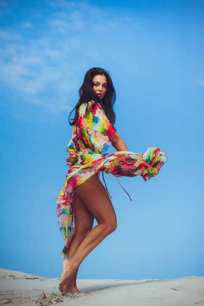 Beautiful young sensual woman on the sand in swimwear - Фото, зображення
