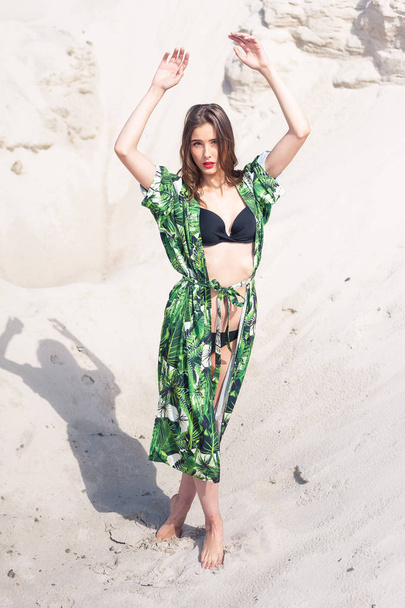 Beautiful young woman chilling on the beach in green swimwear - Valokuva, kuva