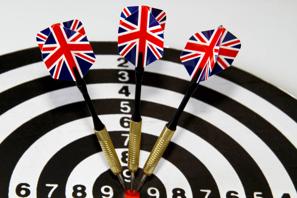 A game of darts with three flags of England on a white background - Fotó, kép