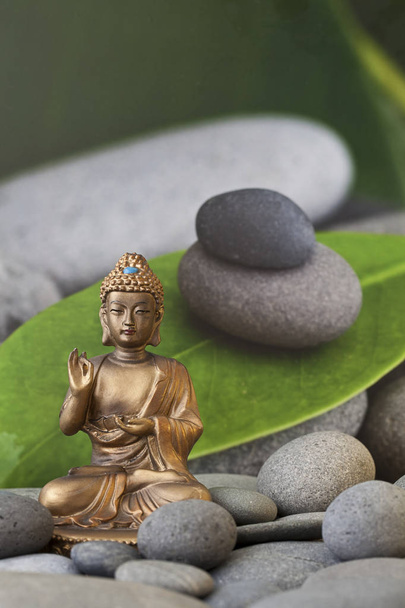 Golden Buddha With Leaf And Pebble - Foto, Imagen