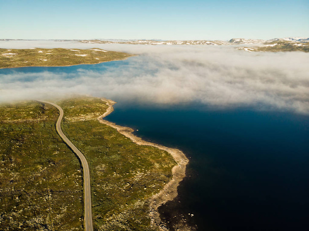 Road crossing Hardangervidda plateau, Norway. Aerial view. - Foto, afbeelding